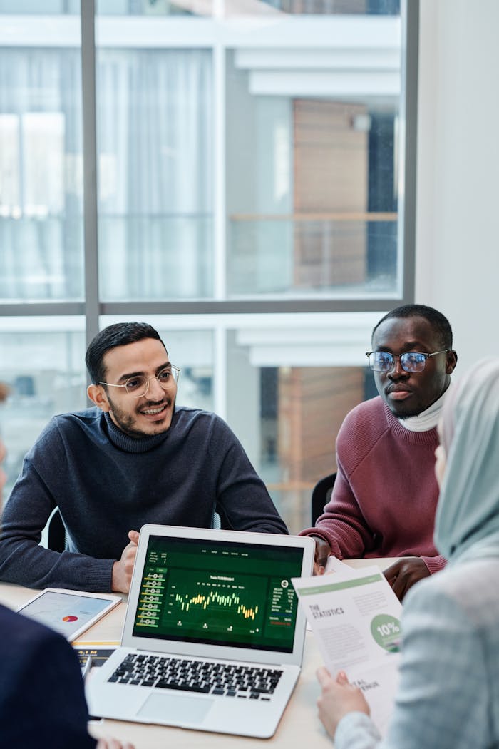 Multiethnic team discussing business analytics data in a modern office meeting.